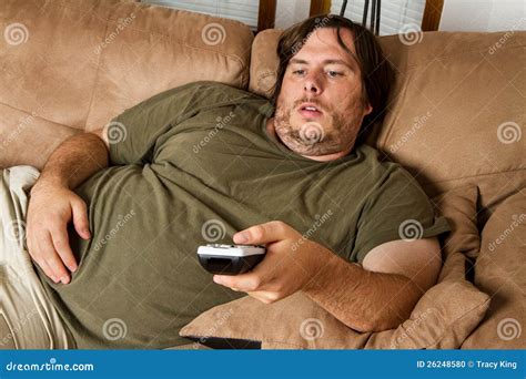 fat man on sofa|lazy guy sitting on couch.